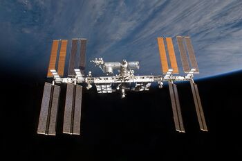 The ISS, photographed in December 2009 by the STS-129 crew of the Space Shuttle Atlantis shortly after undocking to return to Earth. Visible on the ISS are numerous modules, trusses, and long wing-like solar panels.